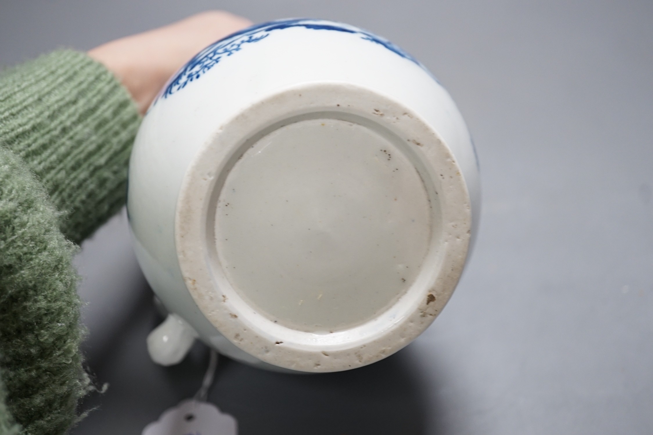 A Caughley baluster mask jug printed in underglaze blue with the 'parrot pecking fruit', 18.5cms high